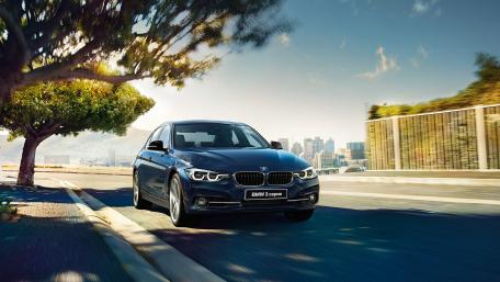 Sleek BMW on a Scenic Urban Road wallpaper