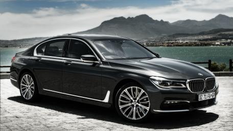 Sleek Luxury Car Against Majestic Landscape wallpaper