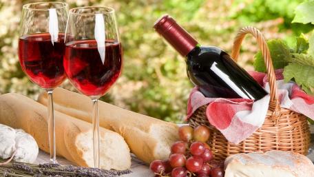Vibrant Wine and Bread Basket Setting wallpaper