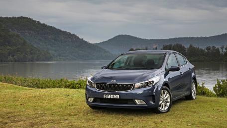 Sleek Kia Car by Serene Lake Scene wallpaper