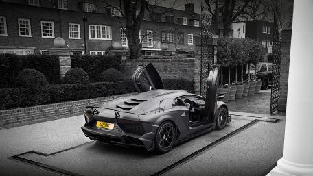 Sleek Black Lamborghini with Open Doors wallpaper