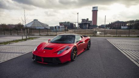 Bold Red Ferrari in an Industrial Setting wallpaper