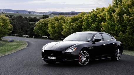 Sleek Luxury Car on a Scenic Road wallpaper