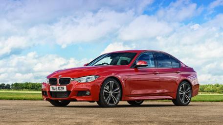 Sleek Red BMW Under Clear Skies wallpaper
