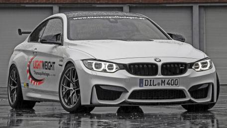 Sleek BMW M4 in the Rainy Urban Landscape wallpaper