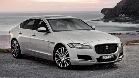 Sleek Jaguar Sedan by the Shore wallpaper
