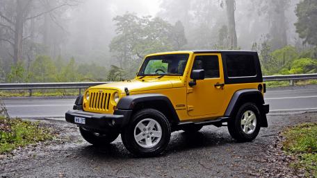 Bold Yellow Jeep in Misty Forest Setting wallpaper