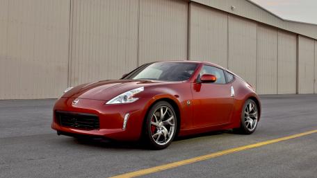 Sleek Red Sports Car Captured in Motion wallpaper