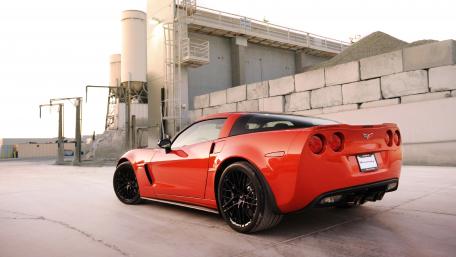 Sleek Red Sports Car in Urban Setting wallpaper