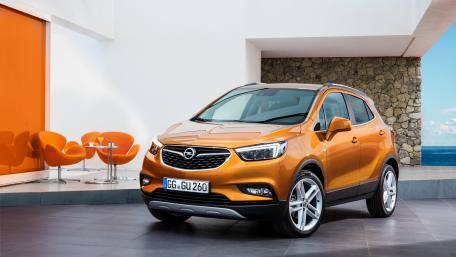 Sleek Orange SUV Under Bright Architecture wallpaper