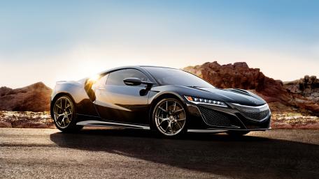 Sleek Black Supercar in a Desert Landscape wallpaper