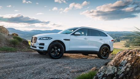 Sleek White SUV on Scenic Landscape wallpaper