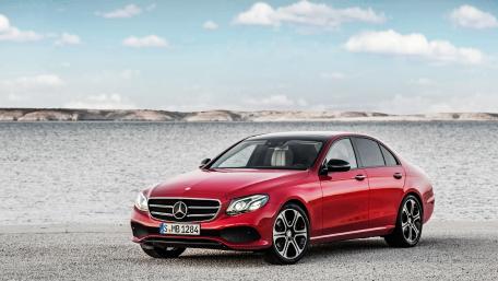 Sleek Red Mercedes Against a Serene Landscape wallpaper