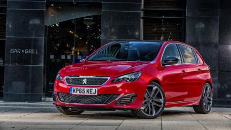 Sleek Red Peugeot Under City Lights wallpaper