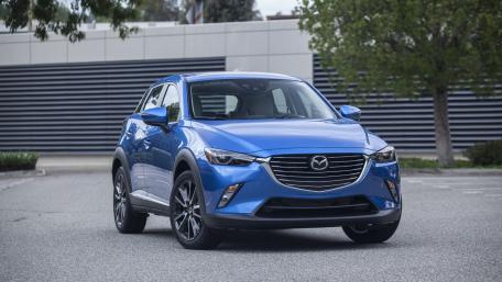 Sleek Blue Mazda Crossover in Urban Setting wallpaper