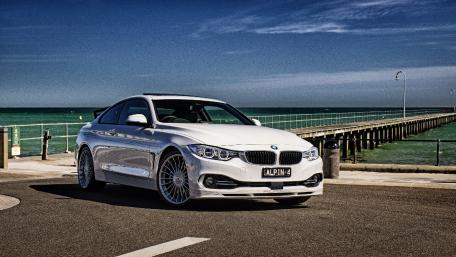 Sleek BMW Coupe by the Ocean Shore wallpaper
