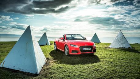 Vibrant Red Convertible Under an Expansive Sky wallpaper