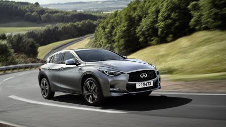 Sleek Infiniti Car on a Scenic Roadway wallpaper