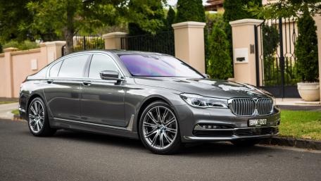 Sleek Luxury Sedan in Urban Setting wallpaper