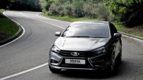 Sleek Vesta Concept Driving Through Serene Curves wallpaper