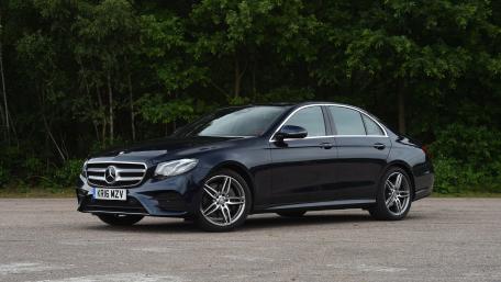 Sleek Luxury Car in Nature Setting wallpaper