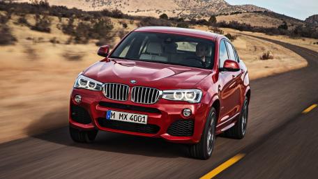 Sleek Red BMW SUV on a Scenic Road wallpaper