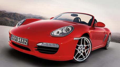 Sleek Red Convertible Against a Mountain Backdrop wallpaper