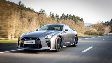 Sleek Nissan GT-R Racing Through Scenic Landscape wallpaper