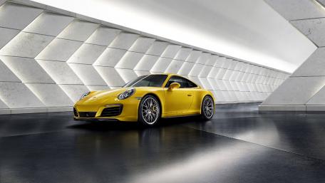 Vibrant Yellow Sports Car in Modern Setting wallpaper