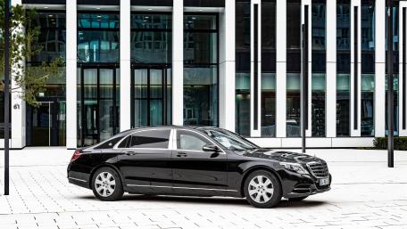 Sleek Black Luxury Sedan in Urban Setting wallpaper