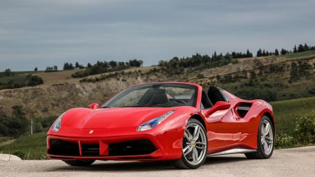 Sleek Red Convertible in Scenic Landscape wallpaper