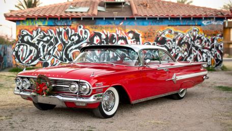 Classic Red Beauty Amidst Vibrant Street Art wallpaper