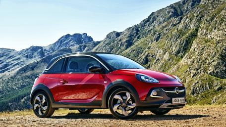 Sleek Red Car Against Majestic Mountains wallpaper