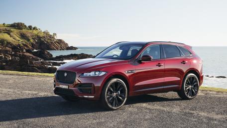 Sleek Red SUV by the Shoreline wallpaper