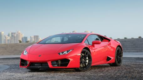 Sleek Red Lamborghini on Urban Background wallpaper