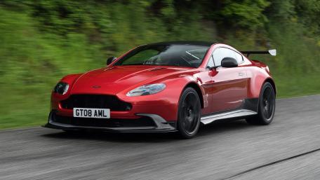 Sleek Red Sports Car in Motion wallpaper