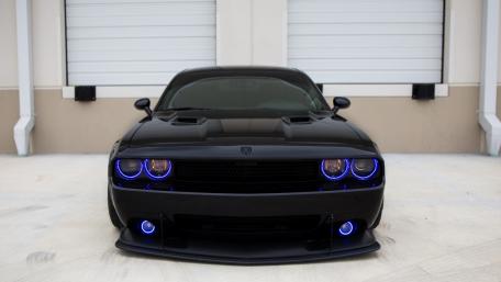 Sleek Black Muscle Car with Blue Accents wallpaper