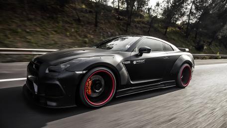 Sleek Matte Black Car on the Move wallpaper
