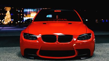 Sleek Red BMW in Urban Night Scene wallpaper