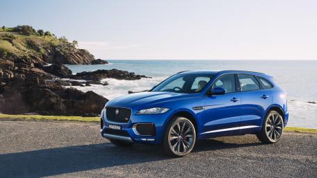 Sleek Blue SUV by the Ocean Shore wallpaper