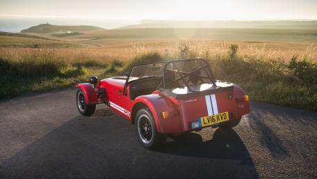 Classic Sports Car Against Scenic Landscape wallpaper