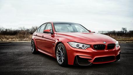 Sleek Red BMW in Urban Landscape wallpaper