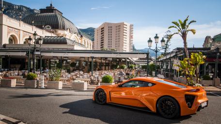 Vibrant Luxury Car on a Scenic Street Scene wallpaper