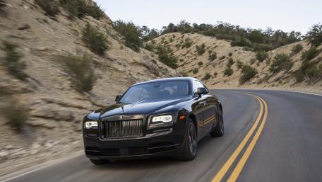 Sleek Luxury Car on Winding Road in Nature wallpaper