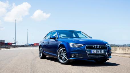 Sleek Blue Audi on a Scenic Roadway wallpaper