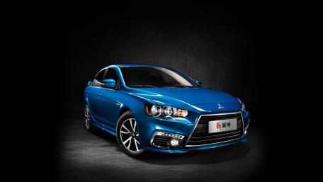 Sleek Blue Car on Dark Background wallpaper