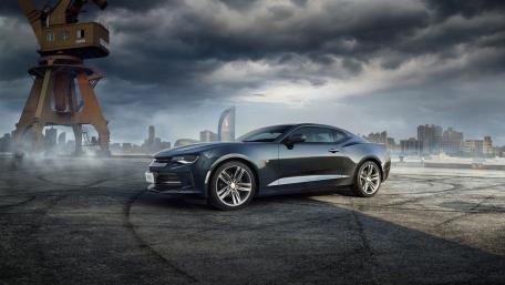 Sleek Muscle Car Against a Dramatic Background wallpaper