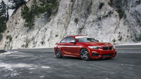 Sleek Red Sports Car on a Mountain Road wallpaper