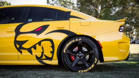 Bold Yellow Charger with Striking Graphics and Glossy Wheels wallpaper