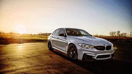 Sleek Silver BMW Under Sunset Glow wallpaper